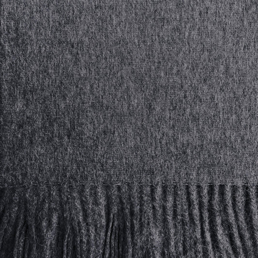 Close-up of a dark charcoal gray woven fabric with a fringed edge along the bottom.
