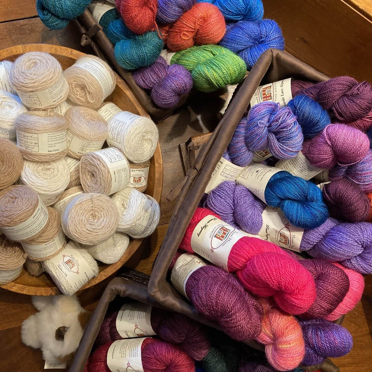 Baskets of balls and skeins of alpaca yarn