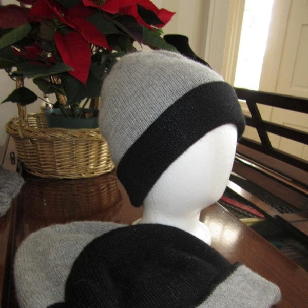 Silver Grey and charcoal grey alpaca hat on a mannequin head with a potted plant in the background