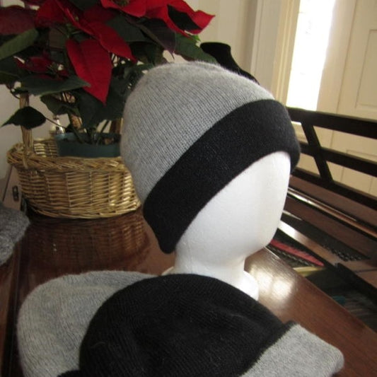 Silver Grey and charcoal grey alpaca hat on a mannequin head with a potted plant in the background