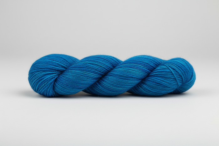 Variegated Blue skein of yarn on a white background