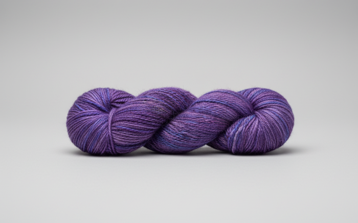 Variegated purple yarn on a gray background