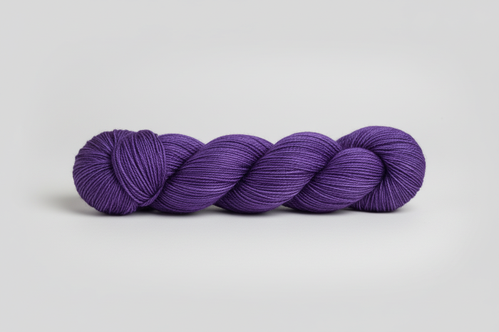 Grape purple yarn skein on a white background