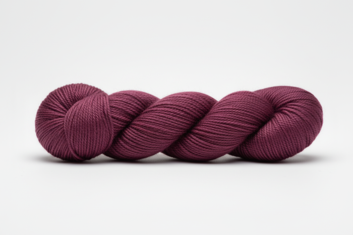 Dark Plum skein of yarn on a white background