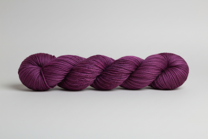 Purple yarn skein on a light gray background