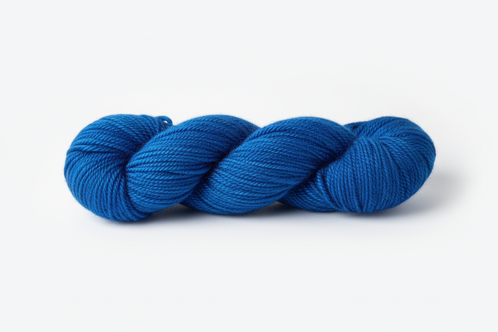 Blue skein of yarn on a white background