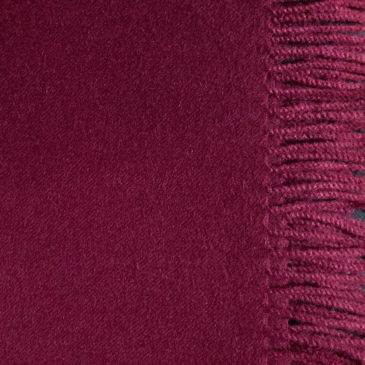 Close-up of a burgundy fabric with a textured border